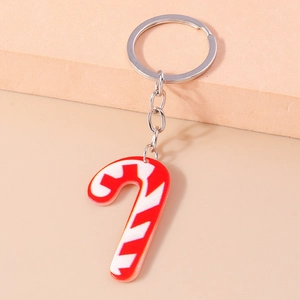 Detail of red and white striped acrylic Christmas candy cane keychain with silver ring