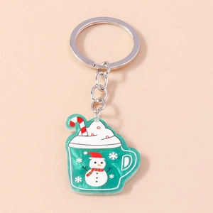 Close-up of green marble resin Christmas mug keychain with snowman and candy cane detail