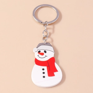 Close-up of cute snowman keychain with grey hat and red scarf on a metallic ring