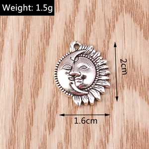Macro detail of sun and crescent moon pendant with 2cm height and 1.5g weight info