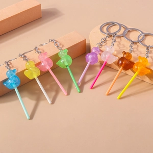 Detail view of colorful duck lollipop keychains with shimmering resin and silver metal rings