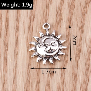 Macro detail of antique silver sun and moon pendant with engraved vintage textures
