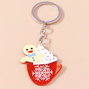Detail of acrylic Christmas coffee cup keychain with glitter red finish and gingerbread man