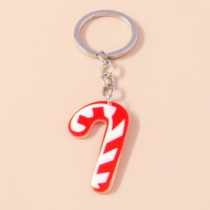Detail of a festive red and white striped candy cane keychain with a silver metal ring
