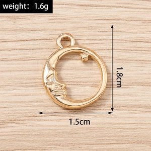 Detailed view of sun and moon gold metal pendant with weight and size specifications