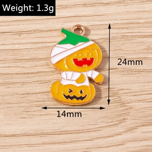 Detail of mummy pumpkin charm with orange enamel and gold finish showing dimensions and weight