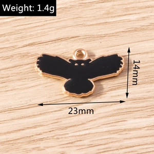 Detailed view of black owl enamel charm with gold metal frame showing 23mm by 14mm size