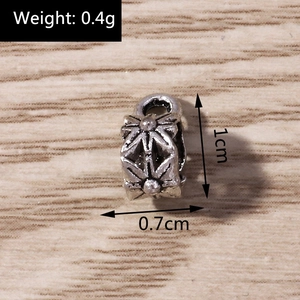 Macro shot of vintage silver-tone star pendant bead showing 1cm size and 0.4g weight detail