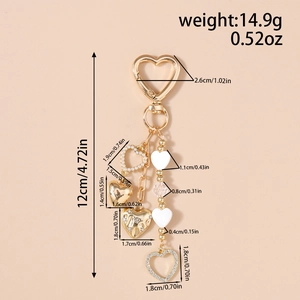 Detail view of heart-shaped keychain with pearls and rhinestones showing size measurements