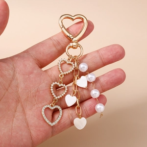 Creative pearl and rhinestone heart keychain with gold heart clip charm for backpacks