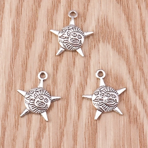 Macro view of vintage silver celestial pendants with sun and moon faces for DIY jewelry
