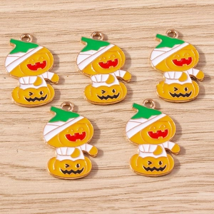 Detailed close-up of 5 Halloween pumpkin mummy charms with orange and white enamel finish