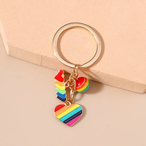 Detail of colorful rainbow heart pendant with drip oil finish on gold-plated keychain