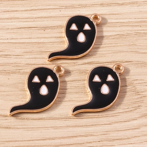 Detailed macro of black ghost Halloween charms with golden alloy edges for DIY jewelry