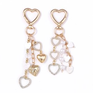 Golden heart keychain set with pearls, rhinestones, and white heart pendants for bags