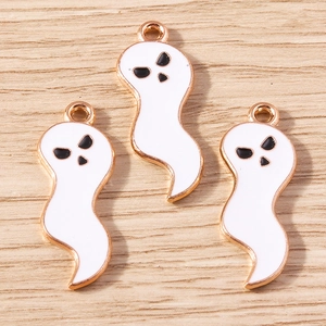 Flat lay macro of three cute cartoon ghost charms for Halloween jewelry making