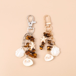 Portachiavi stella marina con pietra occhio di tigre e conchiglie in oro e argento