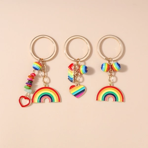 Detail of colorful rainbow charm keychains with gold plating and heart pendants