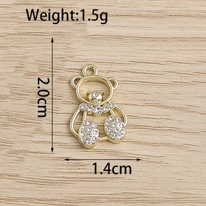 Detailed view of a gold bear pendant with rhinestones measuring 2.0cm by 1.4cm