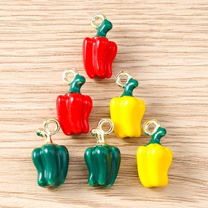 Macro view of colorful enamel chili pepper pendants for DIY jewelry and crafts