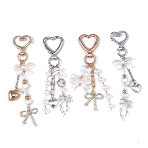 Fashionable heart keychains with pearls and bows in gold and silver metal tones