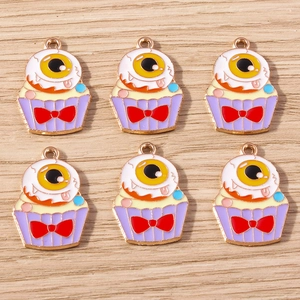 Detailed view of colorful Halloween monster cake charms with gold-plated oil drip finish