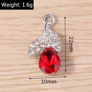 Detail view of red pear-cut crystal pendant with silver leaf design and dimensions