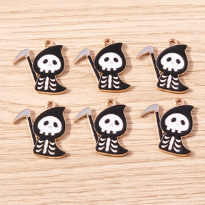 Detail of DIY Halloween reaper charms featuring skeleton skulls and scythes for jewelry