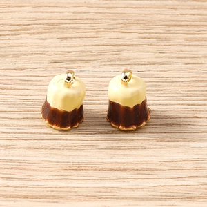Detailed view of caramel canelé dessert charms with golden metal loops for DIY jewelry