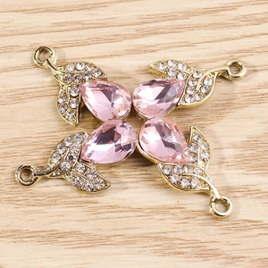 Detailed view of pink pear-shaped gemstone pendants with gold plating and cubic zirconia