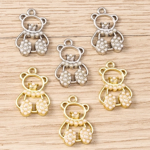 Detail of gold and silver bear-shaped pearl charms for DIY jewelry making sets