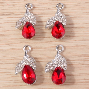 Close-up of four red teardrop crystal pendants with silver rhinestone leaf details