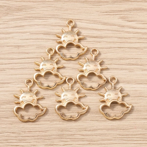 Detailed view of six gold-plated sun and cloud alloy charms for DIY jewelry making