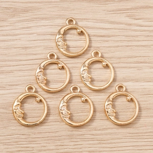 Close-up of golden crescent moon and star charms for DIY jewelry making