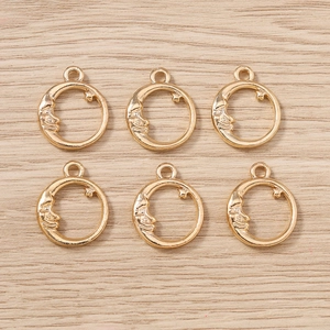 Macro detail of six gold-plated crescent moon and star alloy pendants for DIY jewelry
