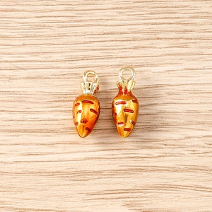 Detailed top view of two creative enamel carrot charms for DIY jewelry making accessories