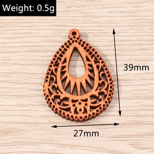 Macro detail of laser-cut wooden teardrop pendant with dimensions 39mm by 27mm