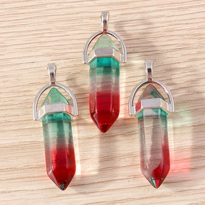 Detailed macro view of three hexagonal crystal bullet pendants with red and green gradient