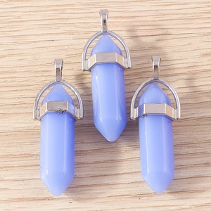 Close-up of lavender hexagonal crystal bullet pendants with polished silver metal caps