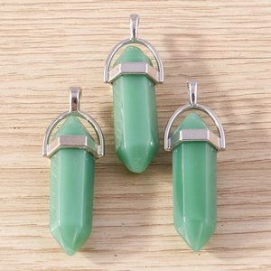 Detail view of three green hexagonal crystal bullet pendants with silver metal clasps