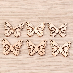 Detail of wooden butterfly pendants with laser-cut hollow patterns for DIY jewelry making