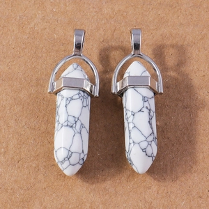 Detail of white turquoise hexagonal bullet pendants with silver-colored wire wrapping