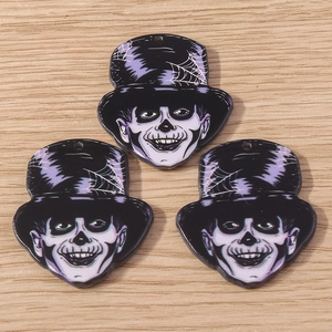 Detailed macro view of three skeleton gentleman pendants for Halloween DIY jewelry making