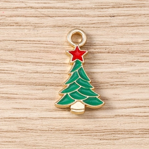 Detailed macro view of green enamel Christmas tree pendant with golden alloy frame and red star