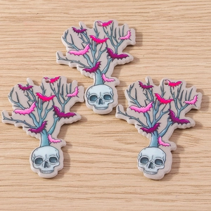 Detailed view of 3 acrylic skull tree pendants with pink bats for DIY jewelry making
