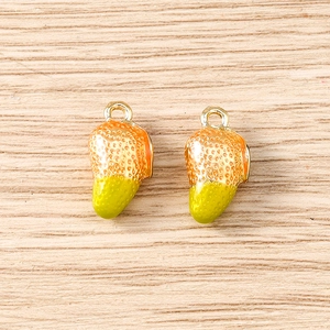 Macro detail of two strawberry charms with realistic texture and golden hanging loops