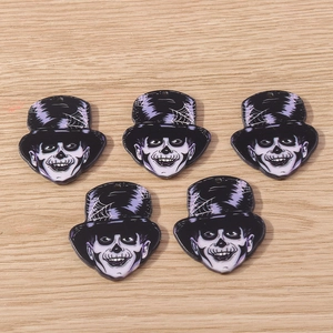 Close-up of five Halloween skull gentleman charms with purple top hats for DIY jewelry