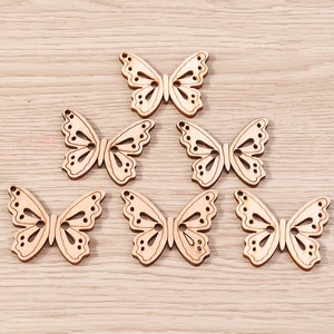 Macro shot of 6 laser-cut wooden butterfly pendants with hollow wing patterns for DIY jewelry