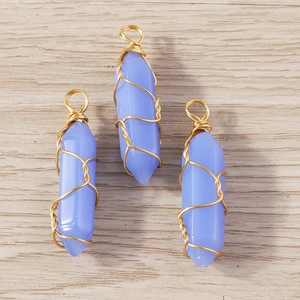 Detailed macro view of lavender crystal hexagonal pillars with golden wire wrapping
