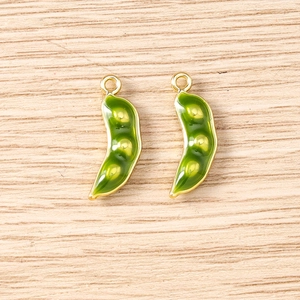 Detail of 3D green pea pod charms with gold metal edges for DIY jewelry making